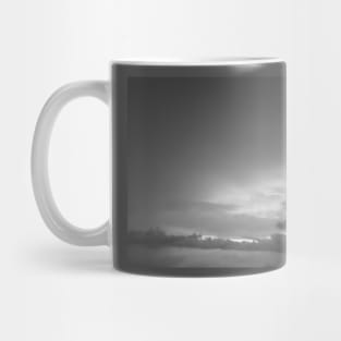 Grey white cloudscape with dark distinctive cloud shapes. Mug